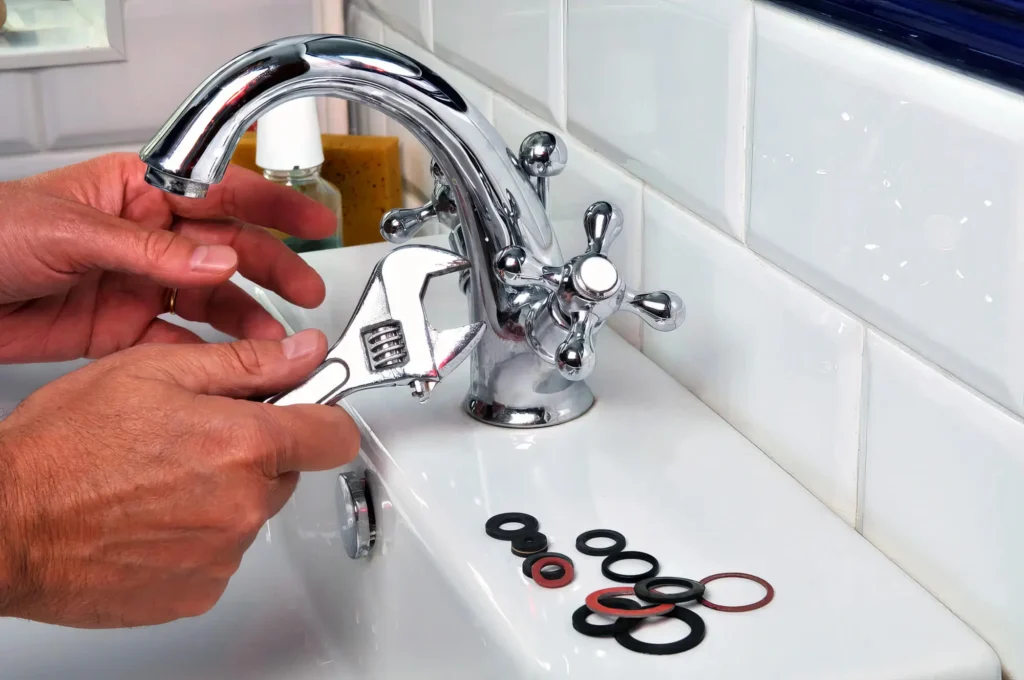 Plumber performing maintenance on a bathroom faucet in Clearwater