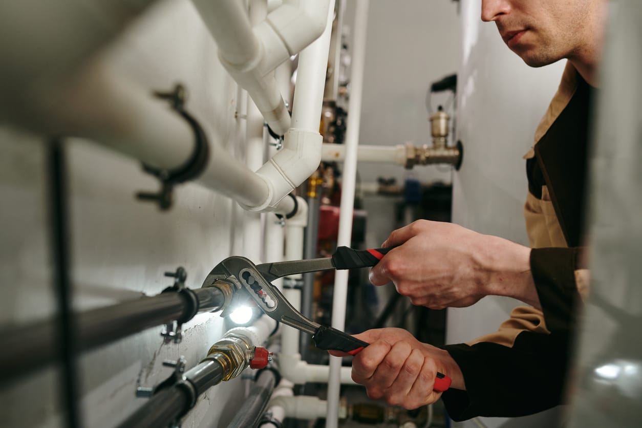 Plumbers maintaining commercial plumbing pipes in Clearwater