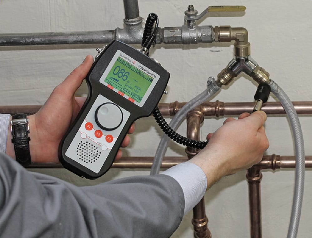 Plumber testing pipes with electronic leak detection equipment in Clearwater