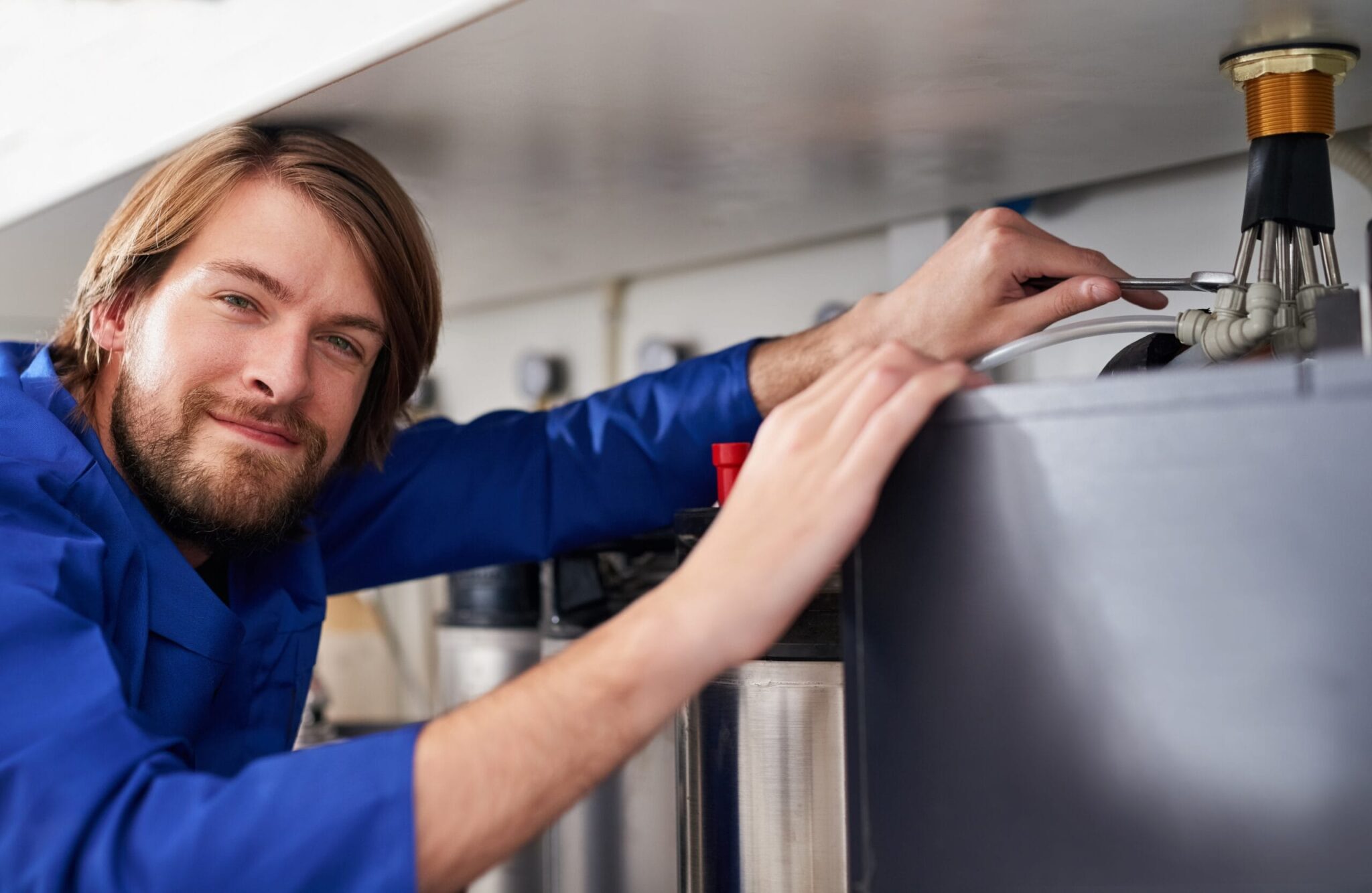 Technician servicing a residential water heater tank in Clearwater